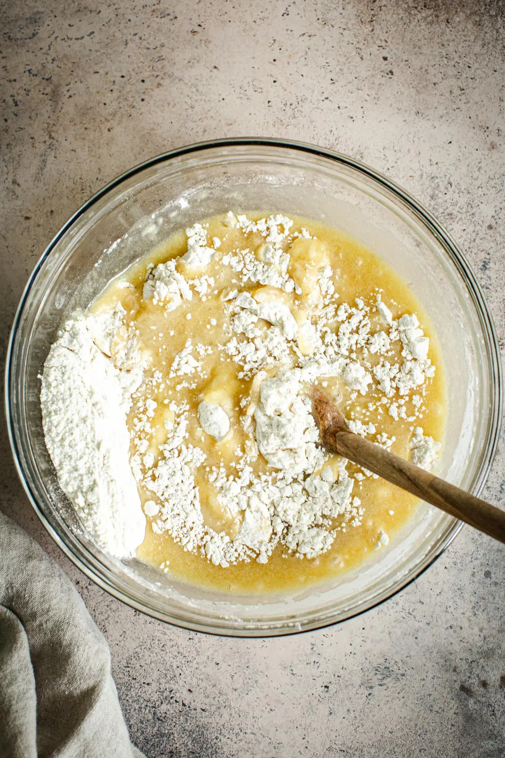 Cinnamon sugar muffin batter in a glass mixing bowl.