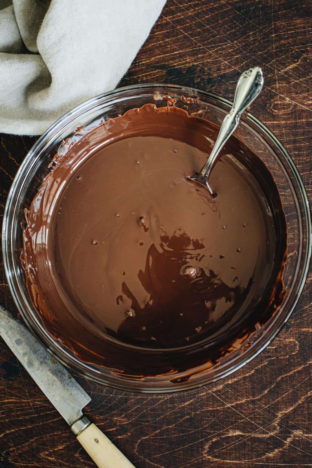 Melted chocolate in a glass mixing bowl.