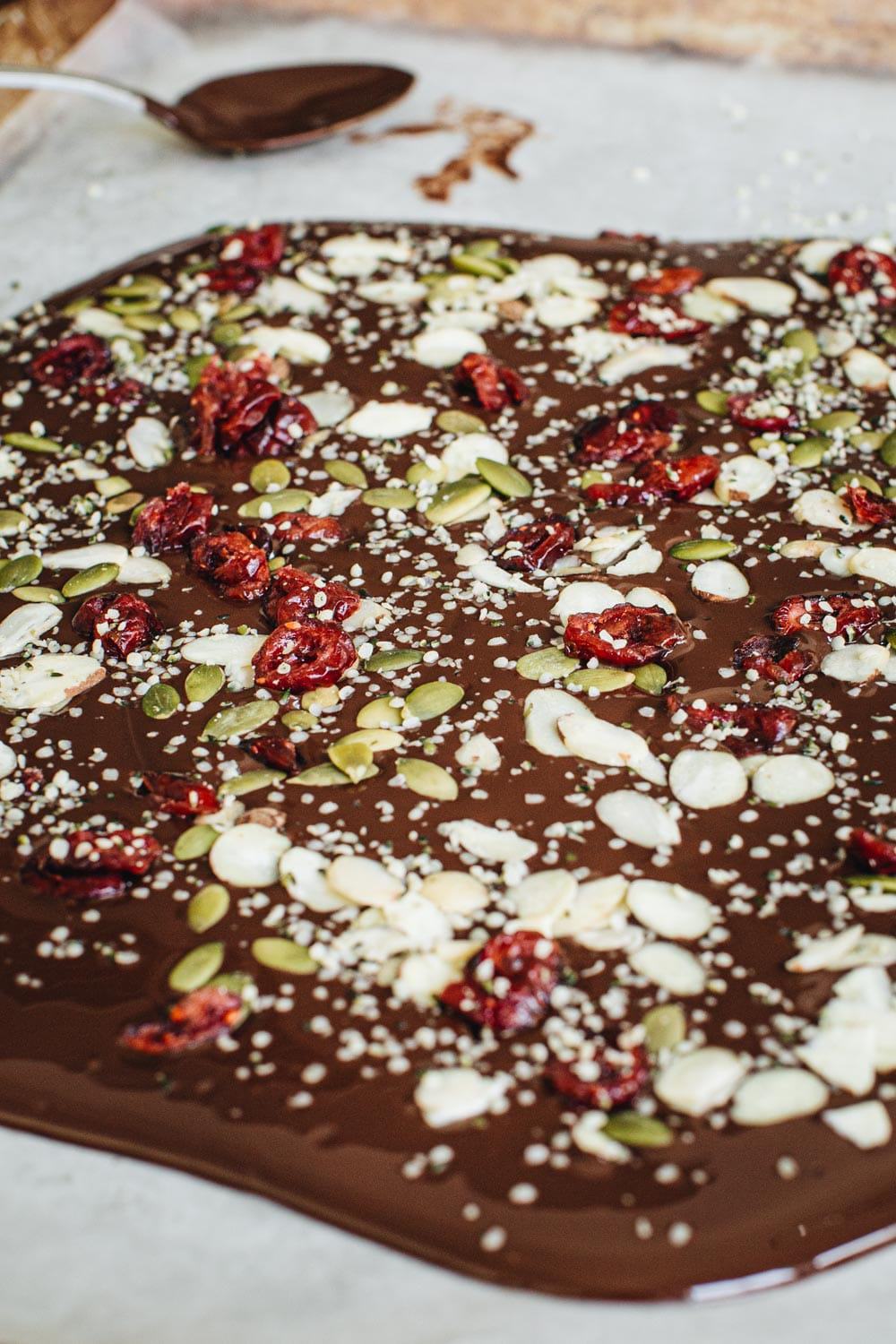 Healthy chocolate bark spread on parchment paper.