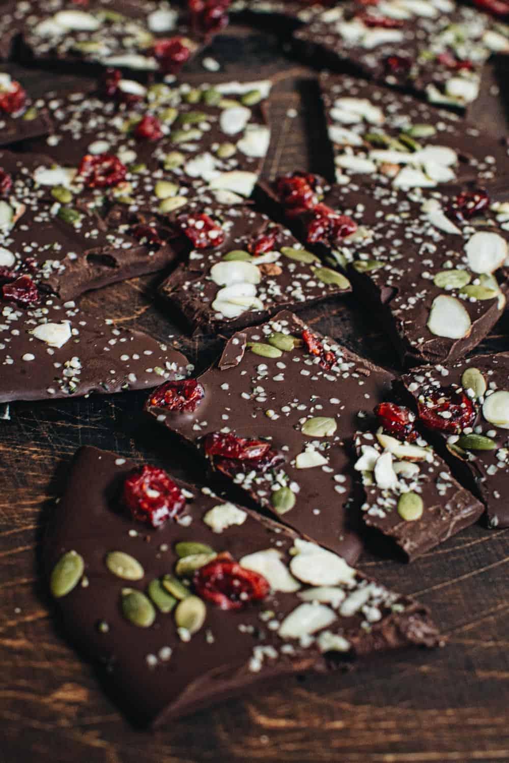 broken pieces of chocolate bark topped with nutritious ingredients