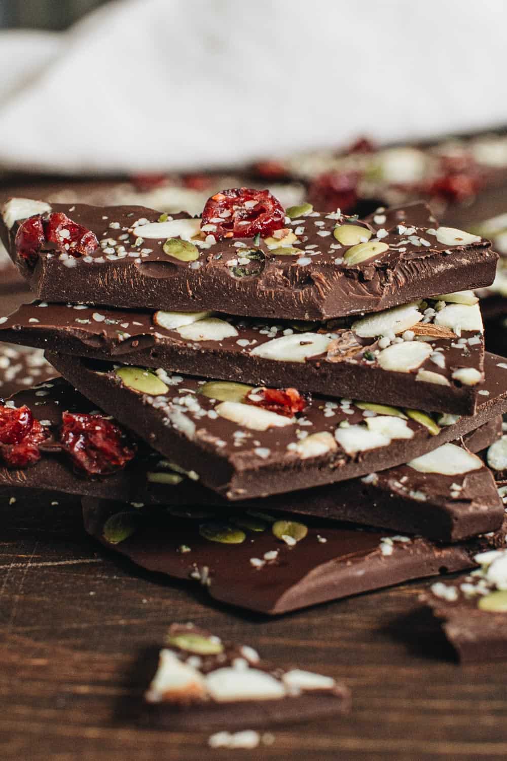 Stacked chocolate bark on wooden table.