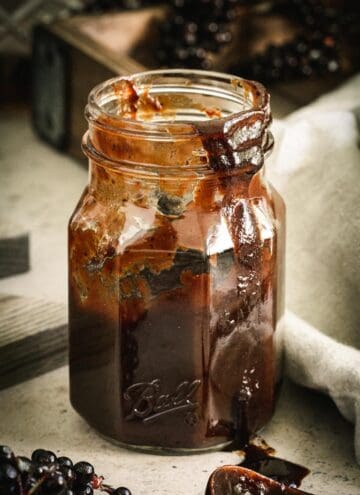 Bbq sauce in ball jar dripping down the side.