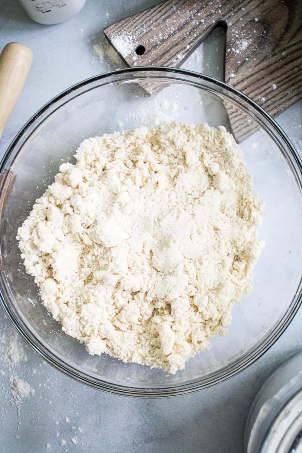 Flakey pie dough in glass bowl.