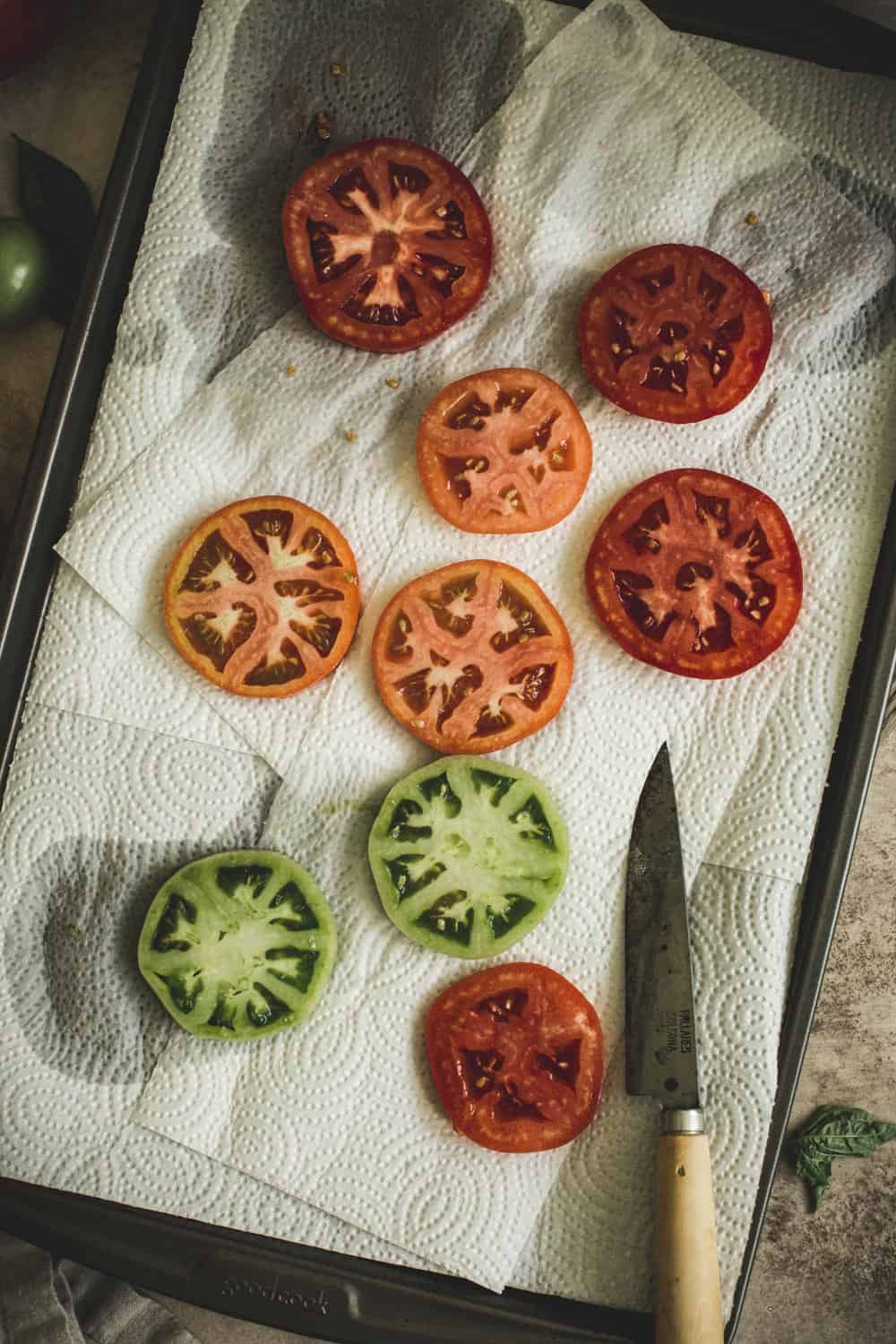 Salted tomatoes on a paper towel.