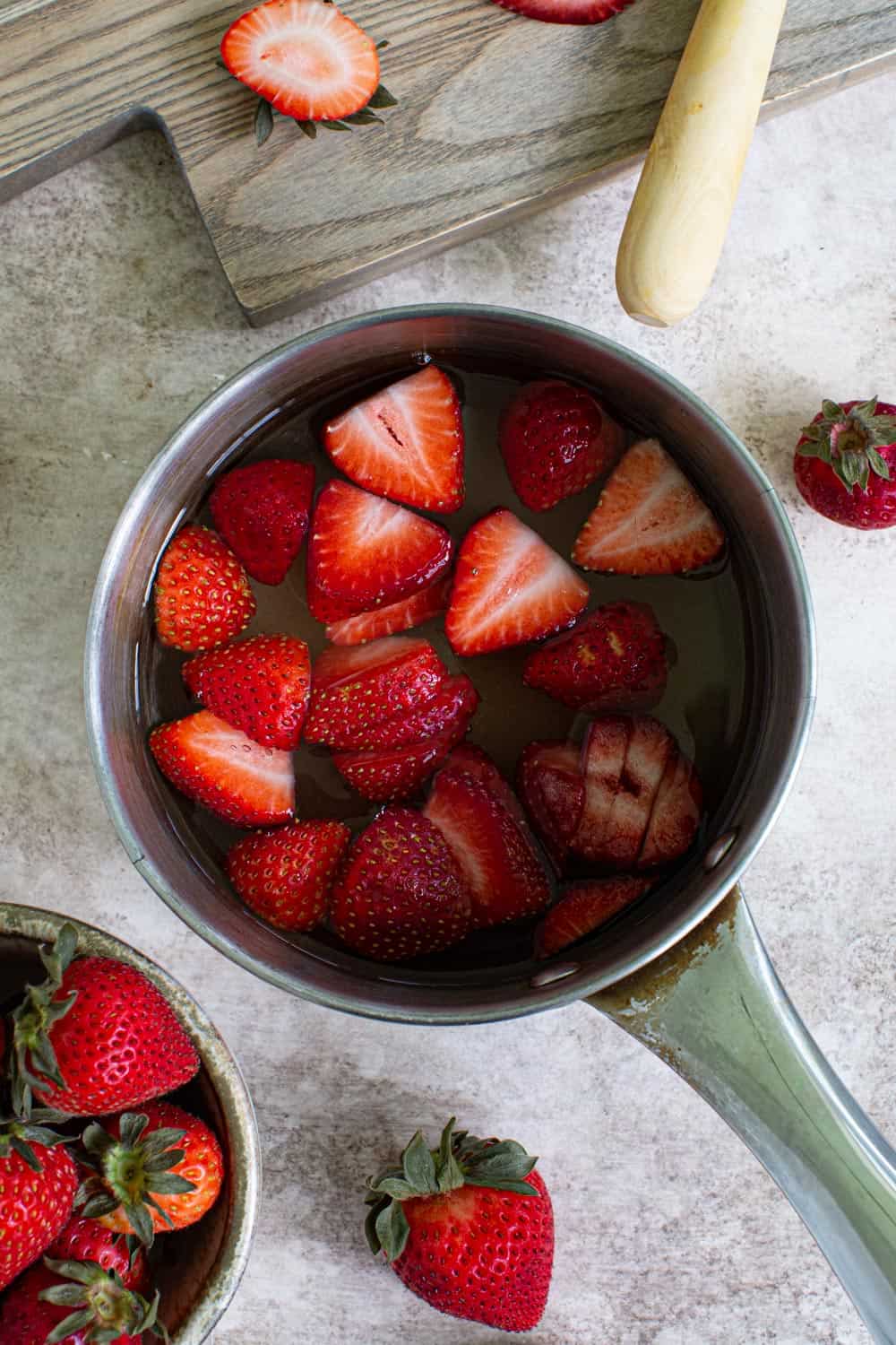 Strawberry sauce mixture in small saucepan.