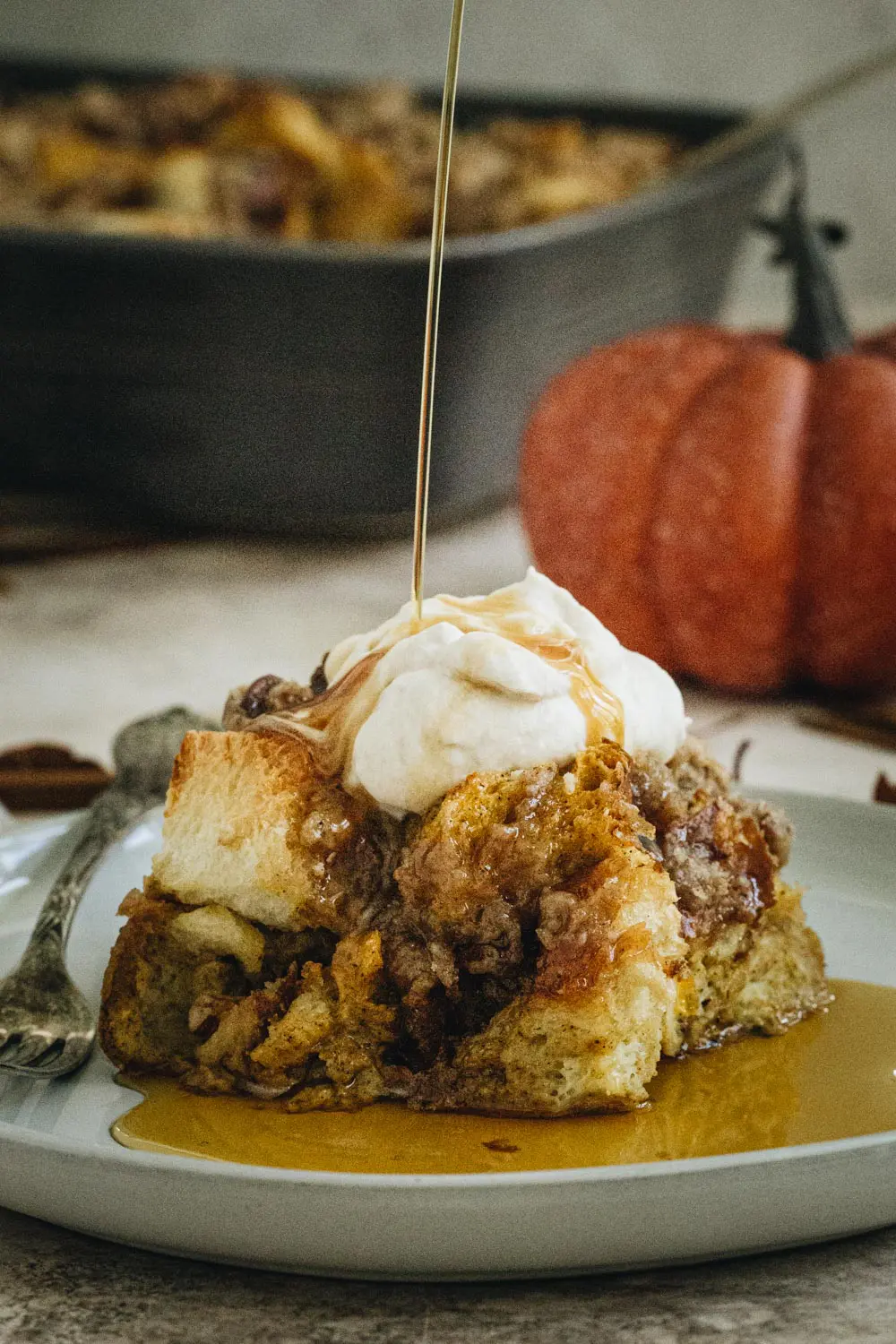 Pumpkin french toast casserole square on a white plate.