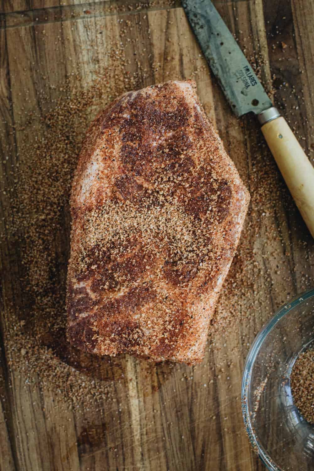 Pork shoulder covered in dry rub.