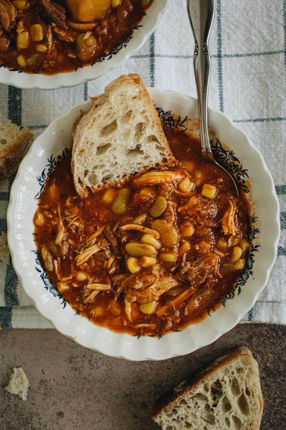 Instant pot Alabama camp stew in a fluted bowl with a slice of bread in it.