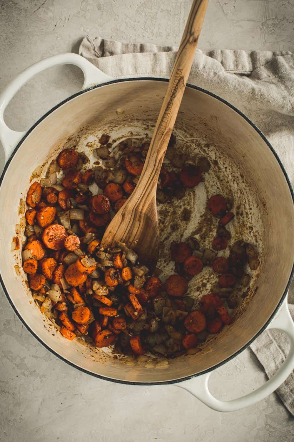 Mixing in the spices with the vegetables for the pumpkin white bean chili.