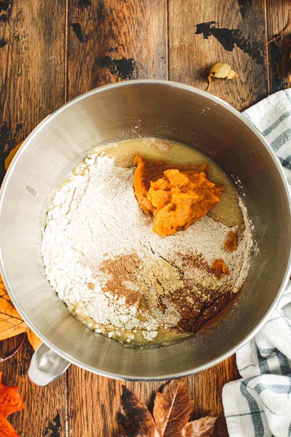 Pumpkin dinner rolls dough in a mixing bowl.