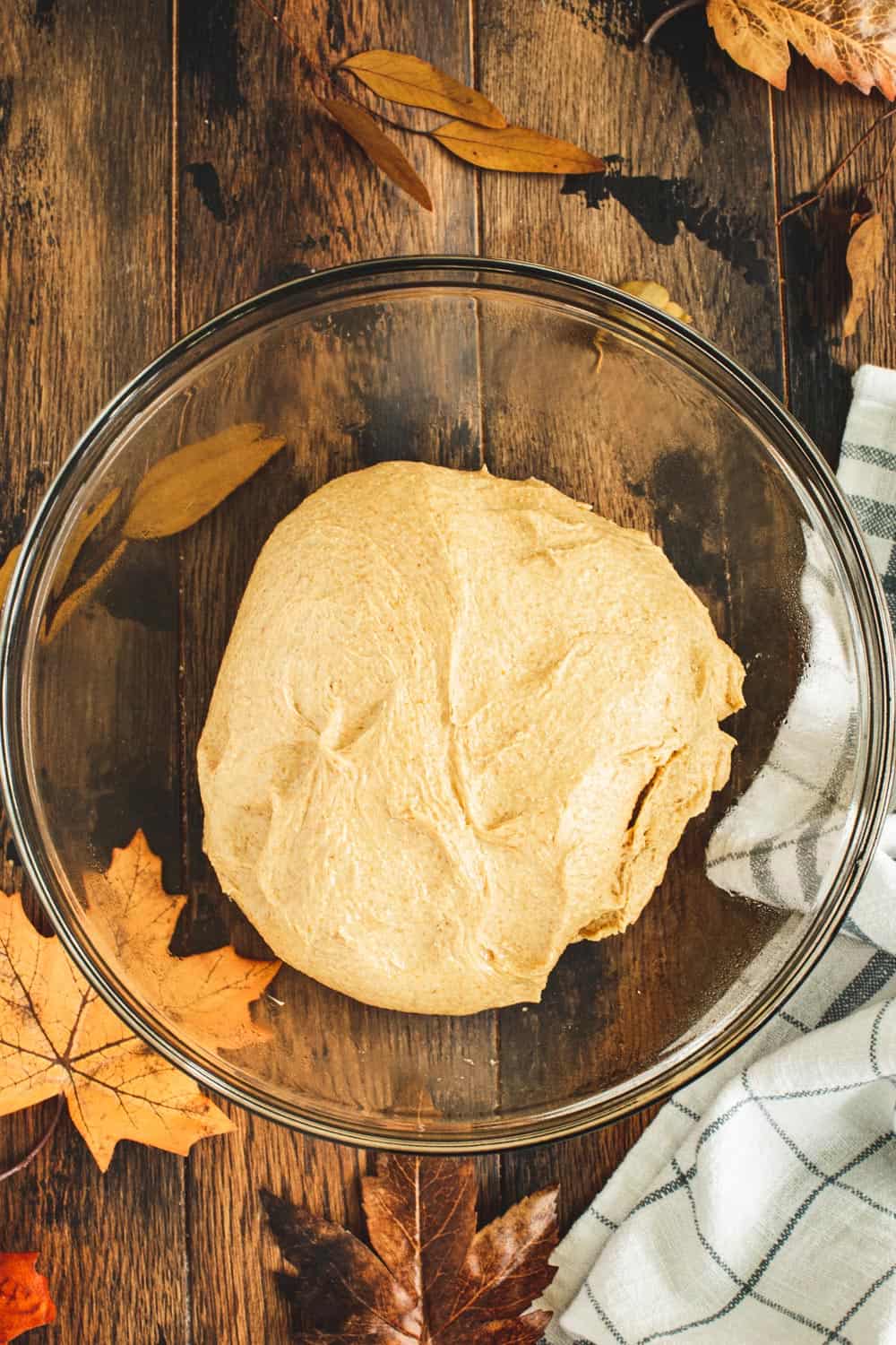 Pumpkin dinner rolls rising in a glass dish.
