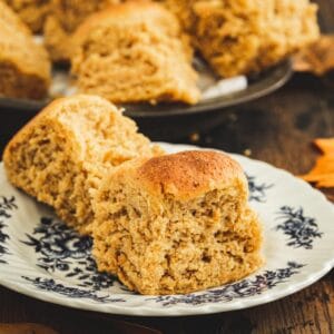 Pumpkin rolls on a white plate with blue flowers.