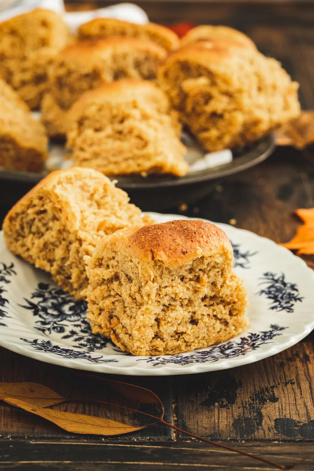 Pumpkin rolls on a white plate with blue flowers.