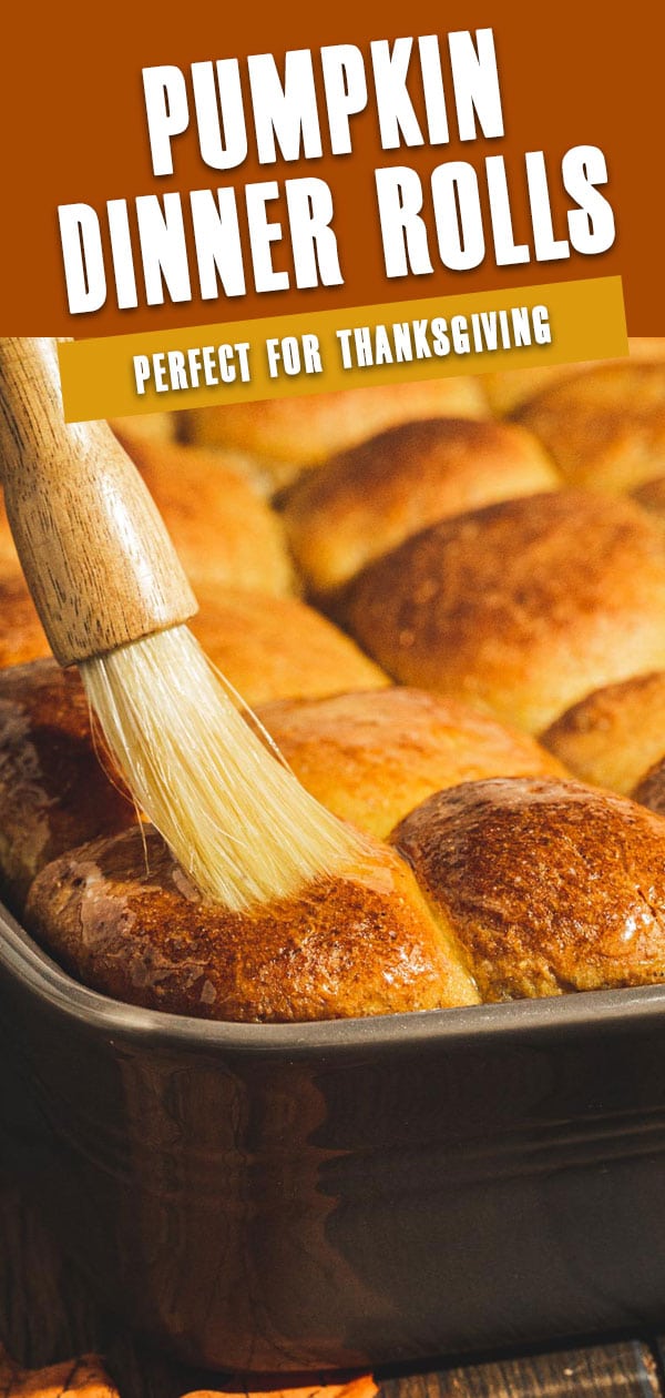 Pumpkin dinner rolls being brushed with butter. Image with white title.