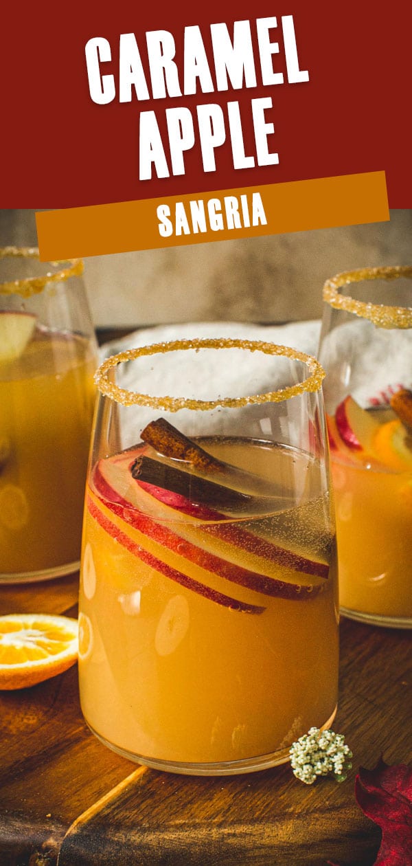 Glass of caramel apple sangria with a caramel coated rim.