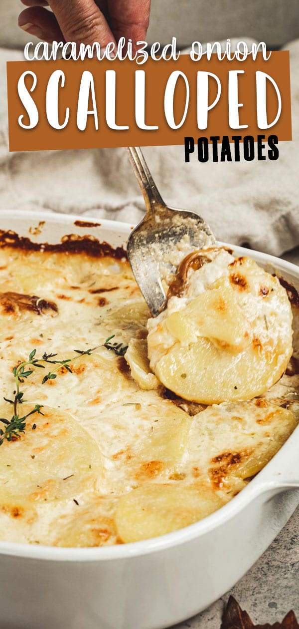 Scalloped potatoes in a white dish with a silver serving fork taking out a serving.