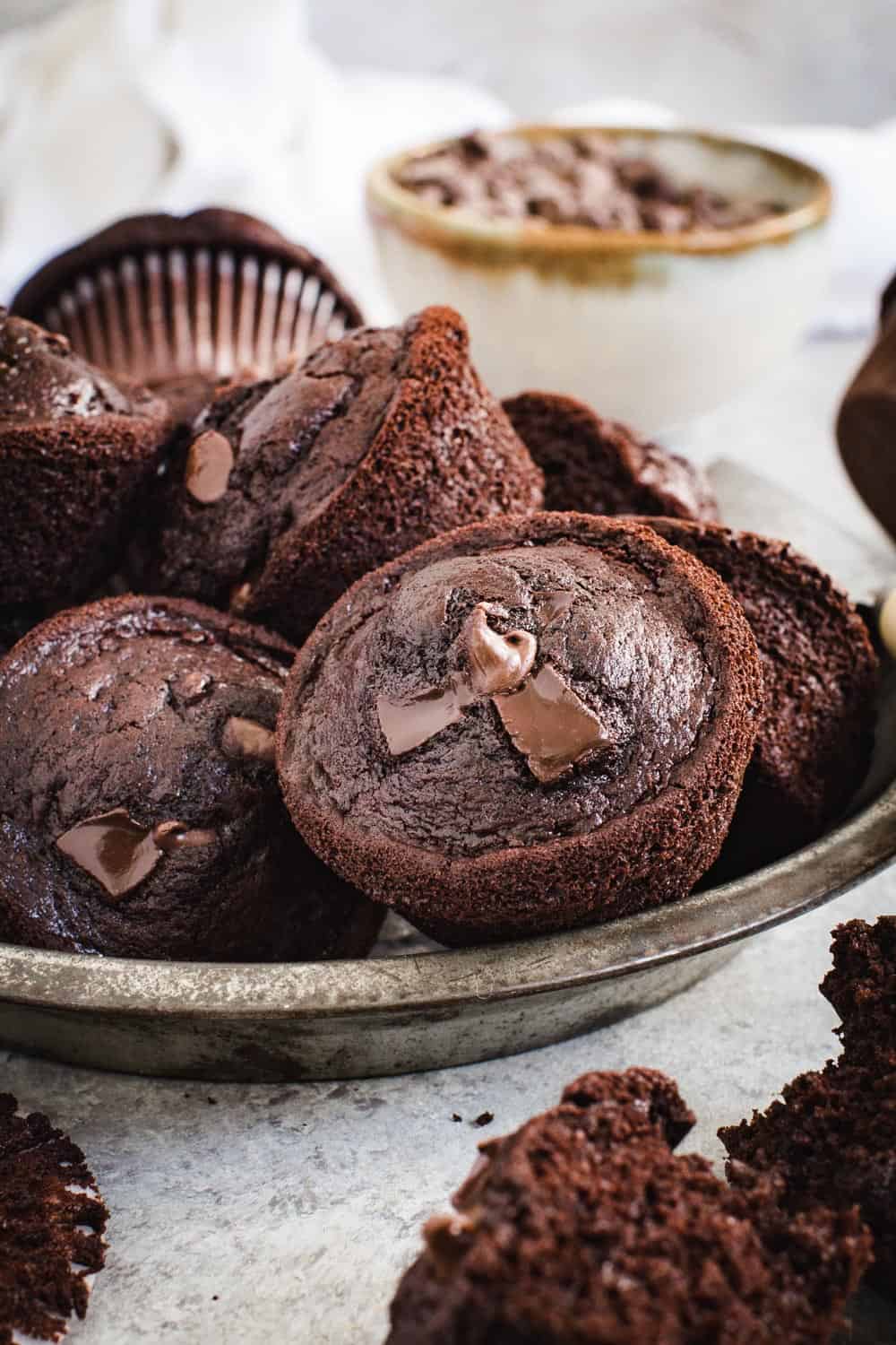 Double chocolate chip muffins sitting in a metal pie tin.