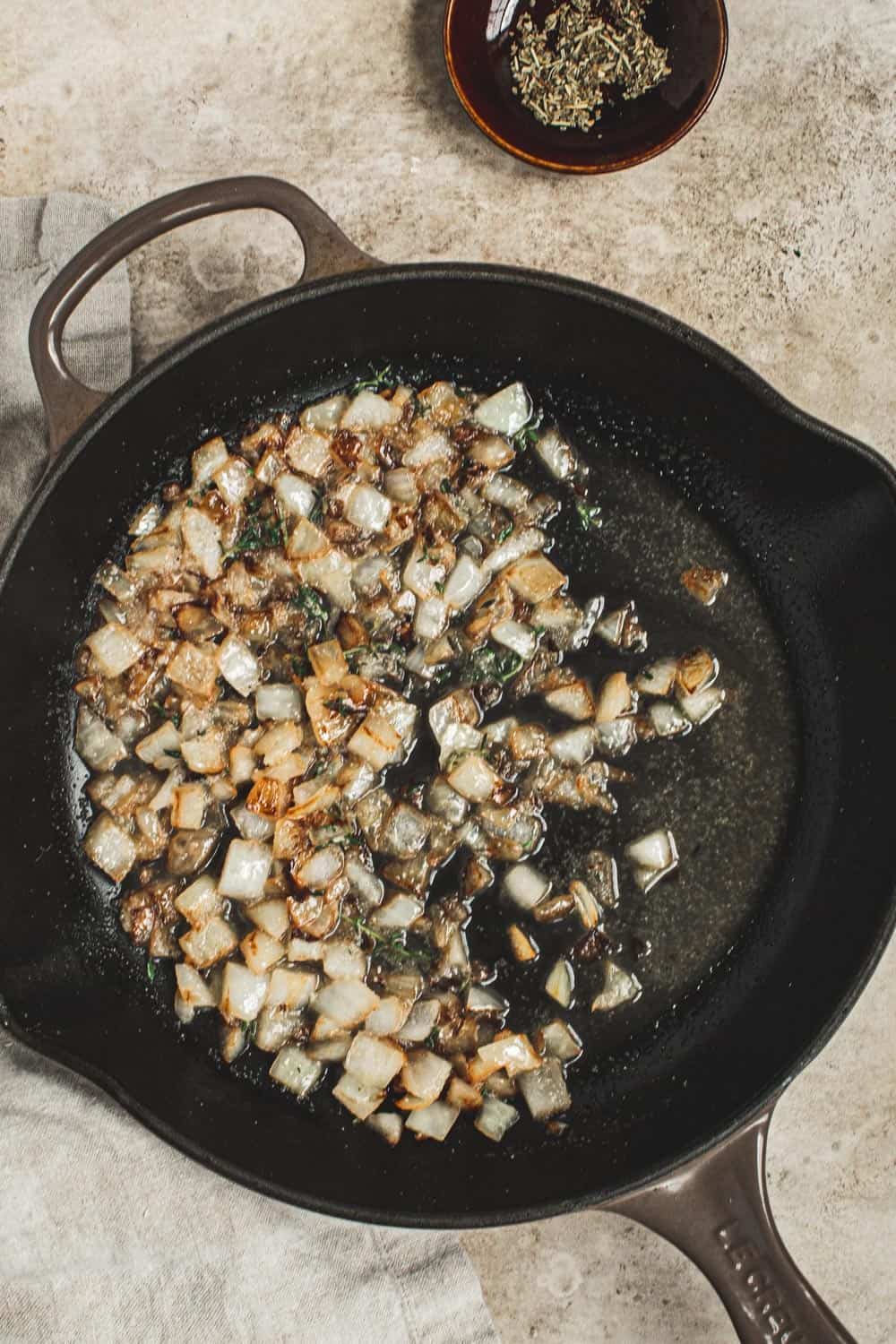Sautéed onions and broth in an iron skillet.