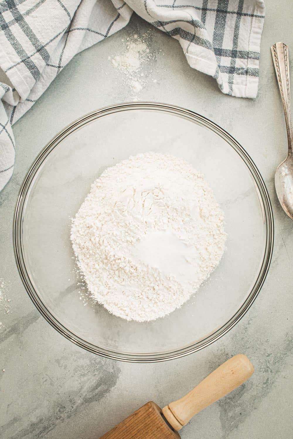 Dry ingredients for pie crust in a glass bowl.