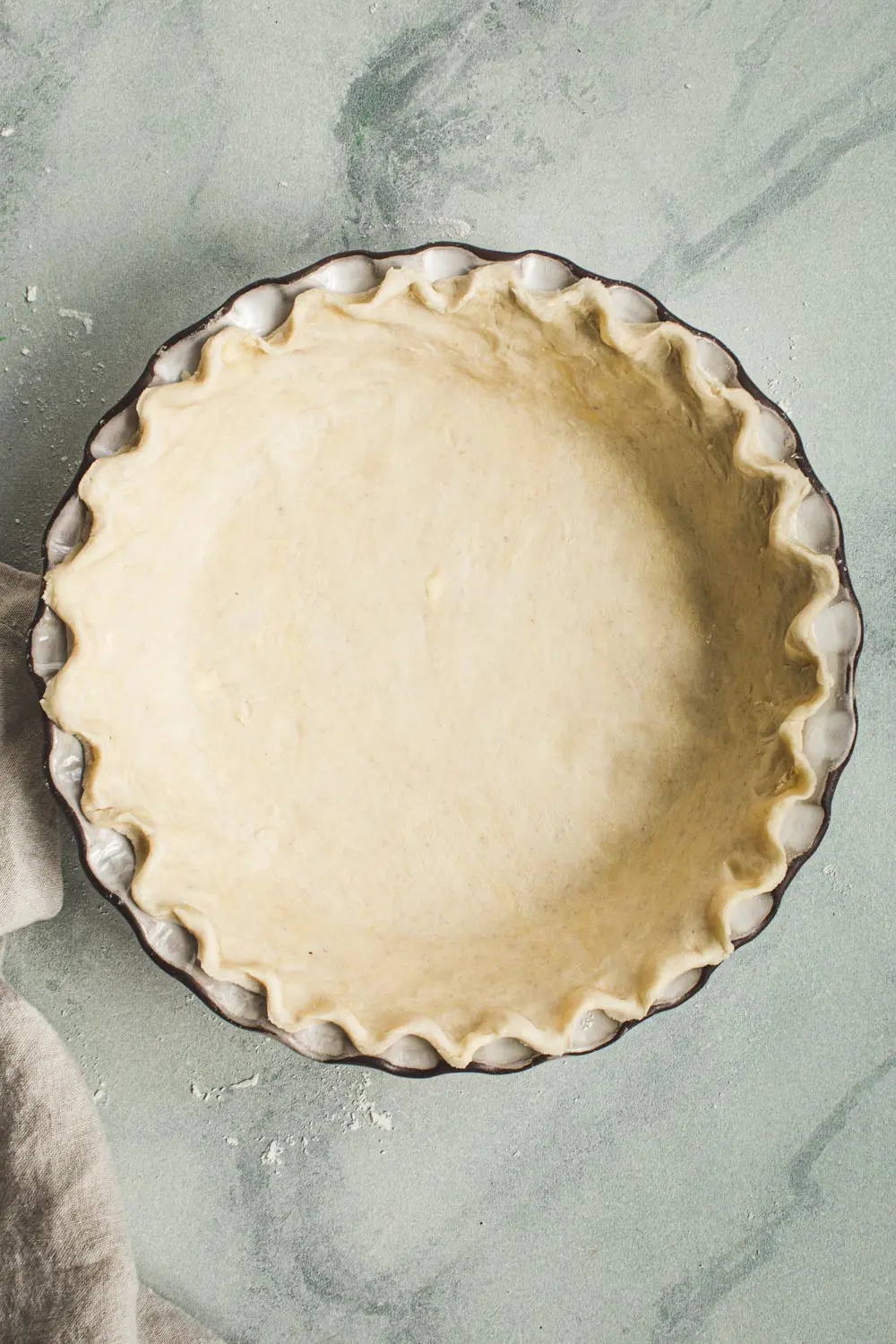 Unbaked pie shell in a pie dish.