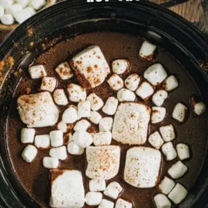 Slow cooker pumpkin hot chocolate topped with marshmallows image with title for Pinterest.