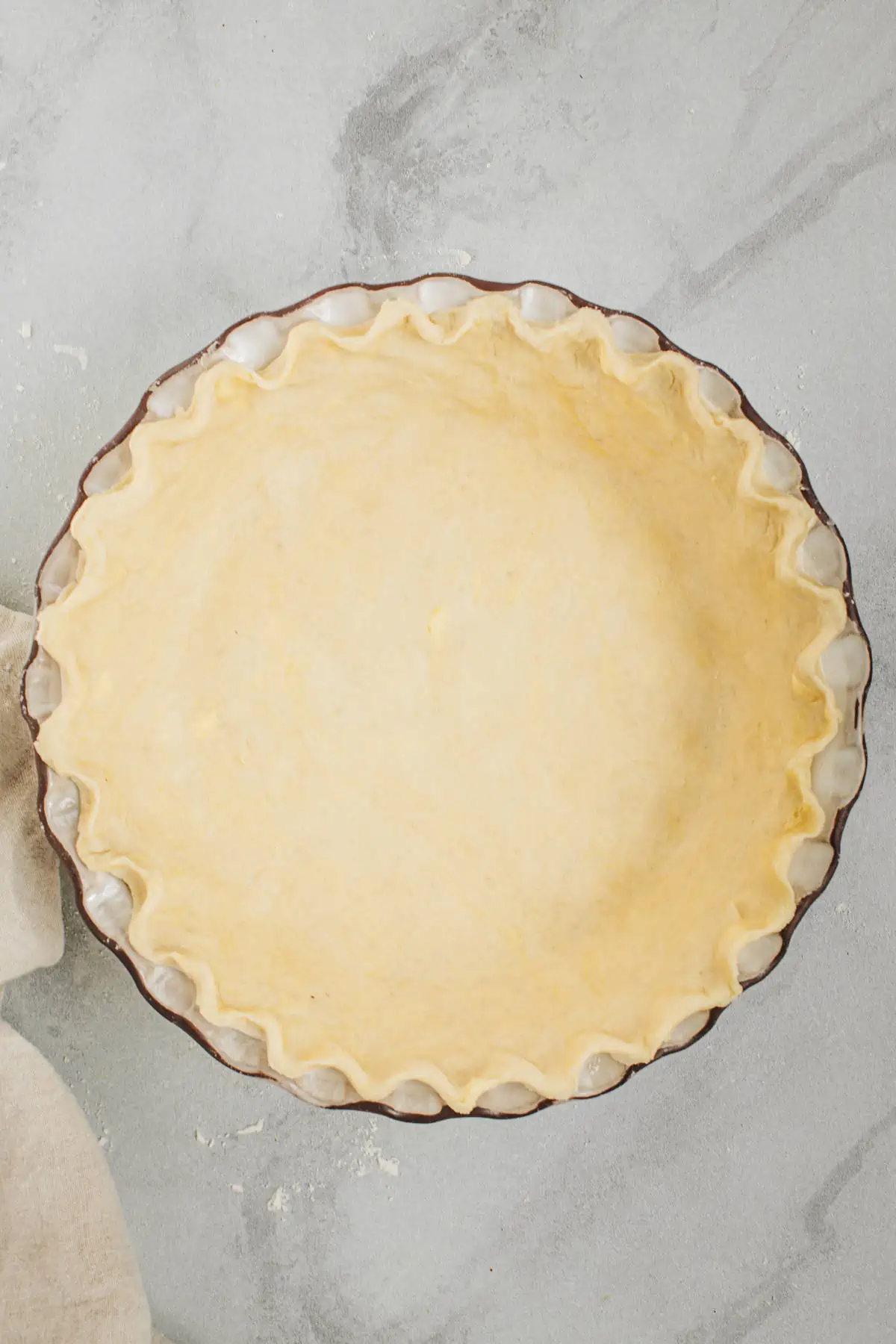 Pie crust with shortening in a pie dish.