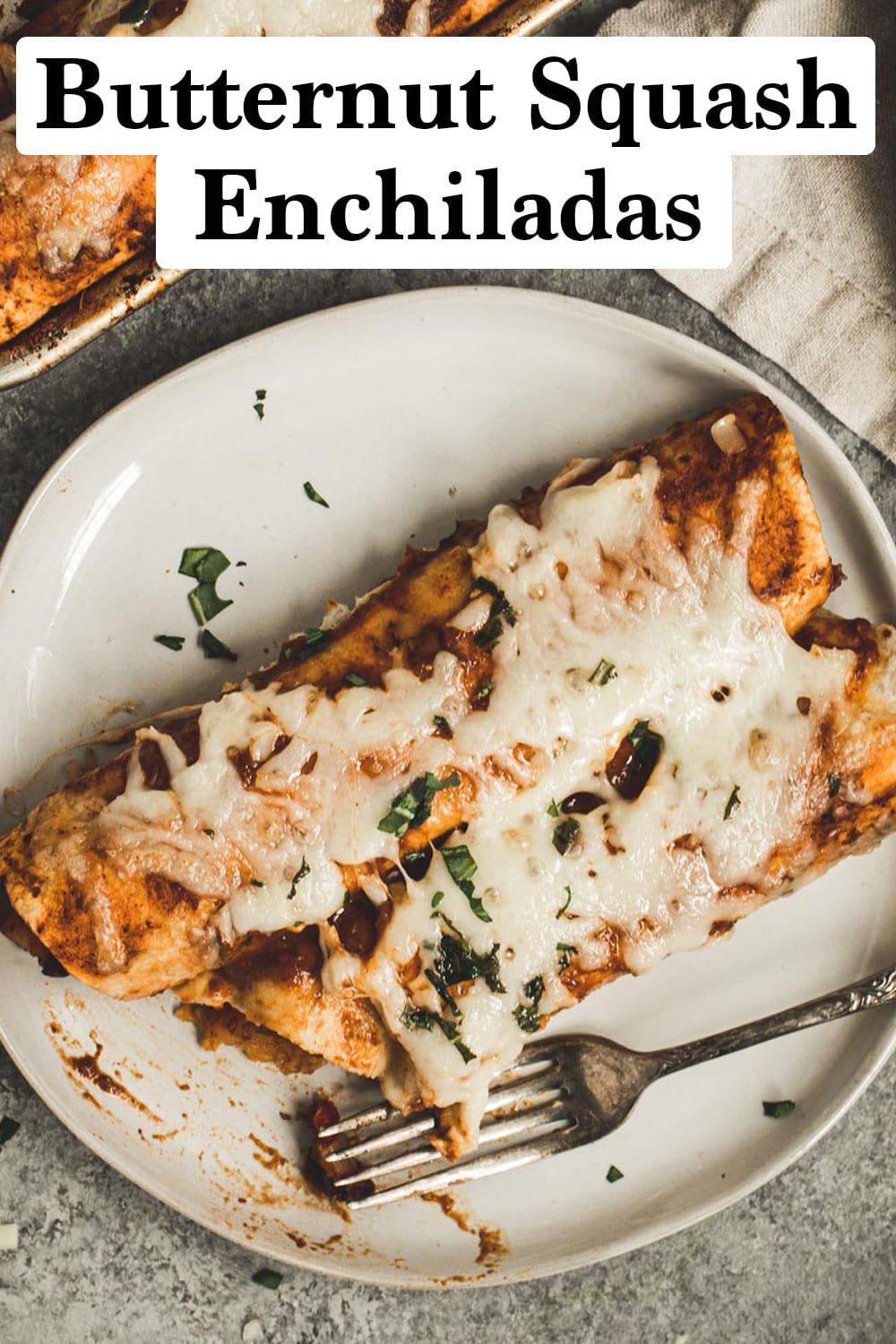 Butternut squash enchiladas on a plate with a silver fork.