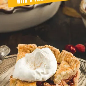 Apple and cranberry pie slice topped with whipped cream Pinterest image with lettering.