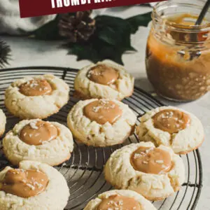 Thumbprint cookies on a wire rack with red and green title for Pinterest.