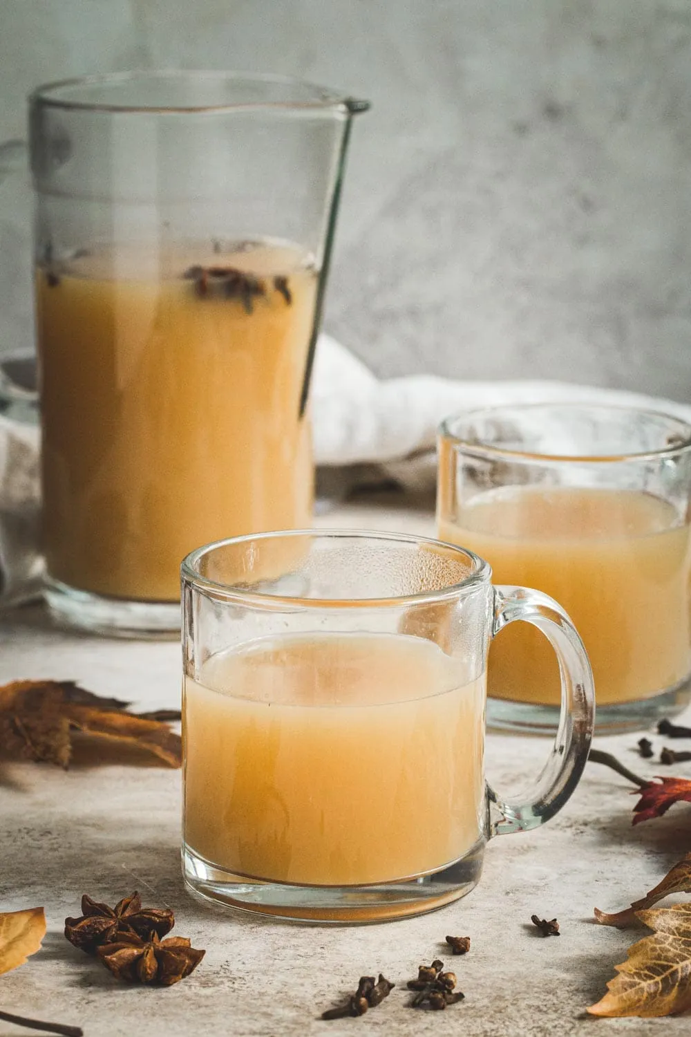 Caramel Bourbon Apple Cider cocktail in a clear mug.