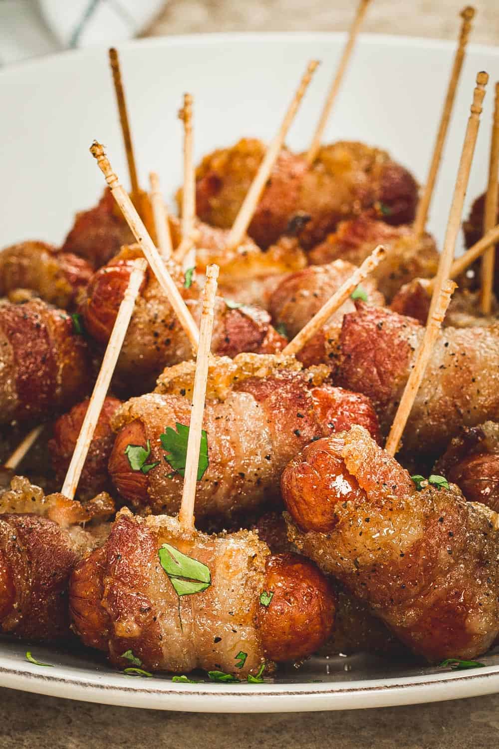 Bacon wrapped little smokies topped with fresh parsley.