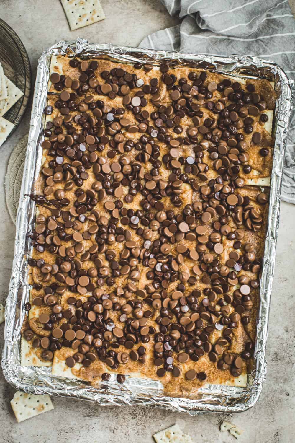 Saltine toffee bark topped with chocolate chips.