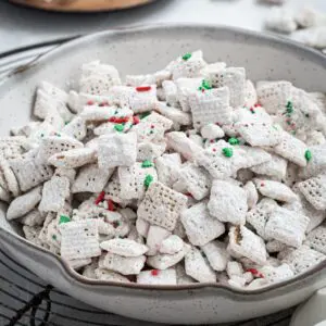 Peppermint puppy chow in a white pottery bowl.