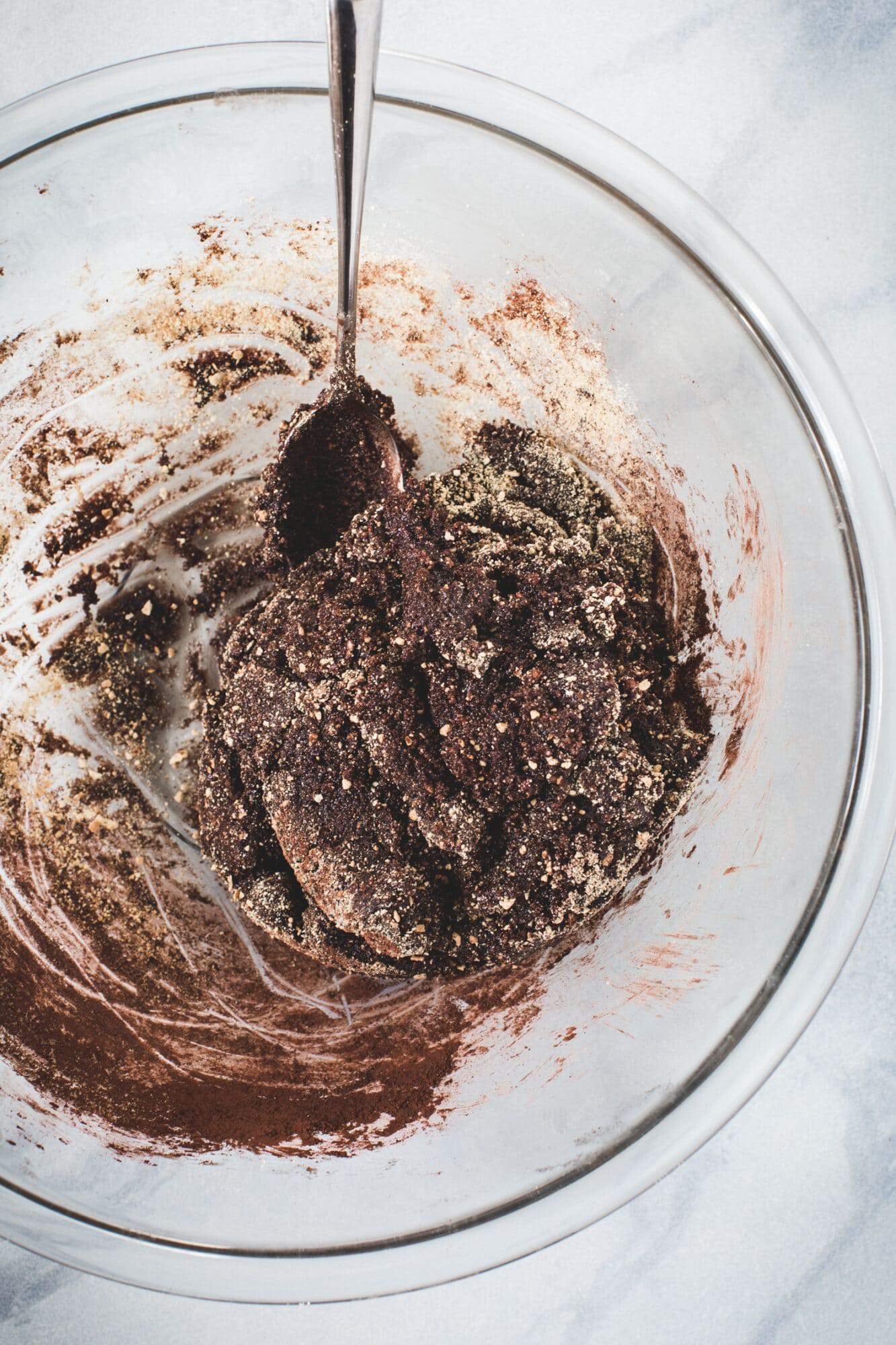 Chocolate rum ball batter in a glass mixing bowl.