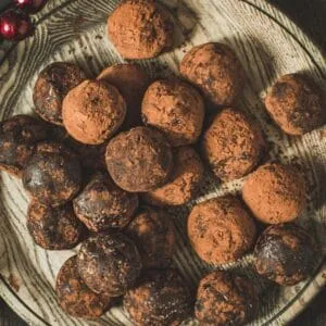 Chocolate Rum Balls on a wooden plate.