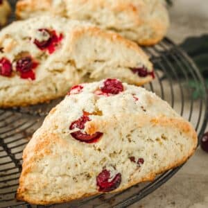 Cranberry scones on a wire rack.