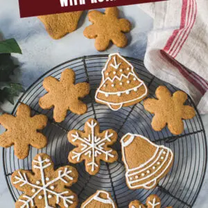 Cutout gingerbread cookies on a wire rack with white title for Pinterest.