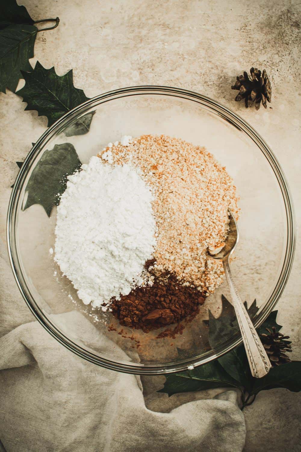 Old fashioned rum ball dry ingredients in glass mixing bowl.