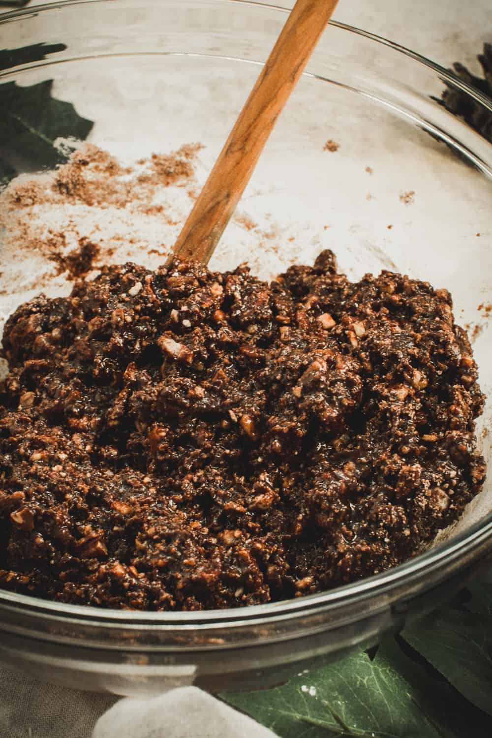 Old fashioned rum ball batter in a glass mixing bowl.
