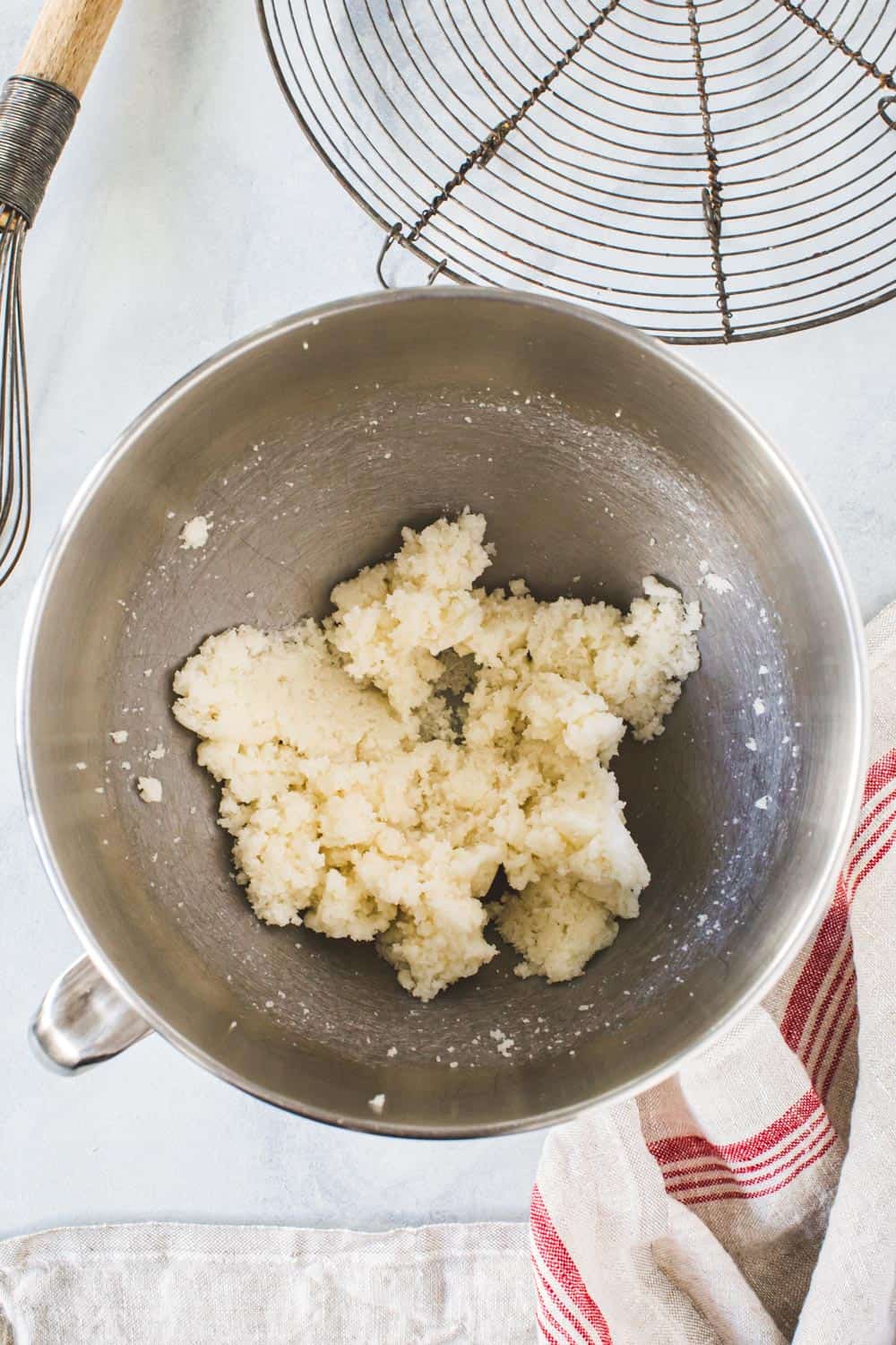 Butter for gingerbread cookies in silver mixing bowl.