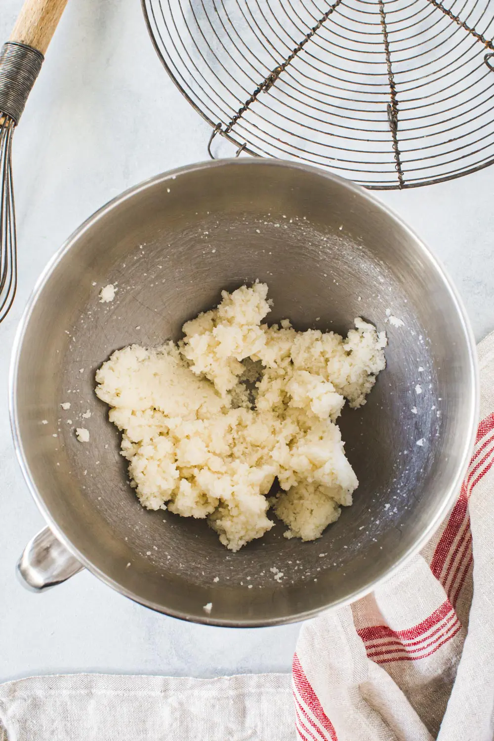 Butter for gingerbread cookies in silver mixing bowl.