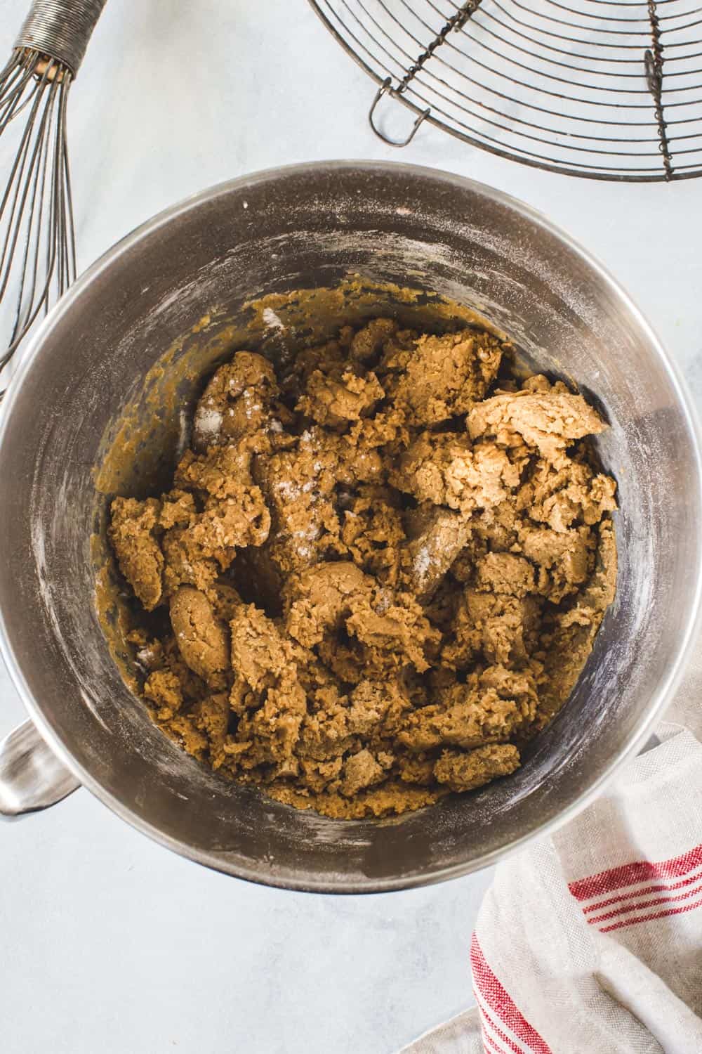 Gingerbread cookie dough in silver mixing bowl.