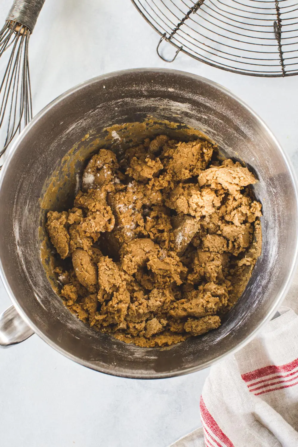 Gingerbread cookie dough in silver mixing bowl.