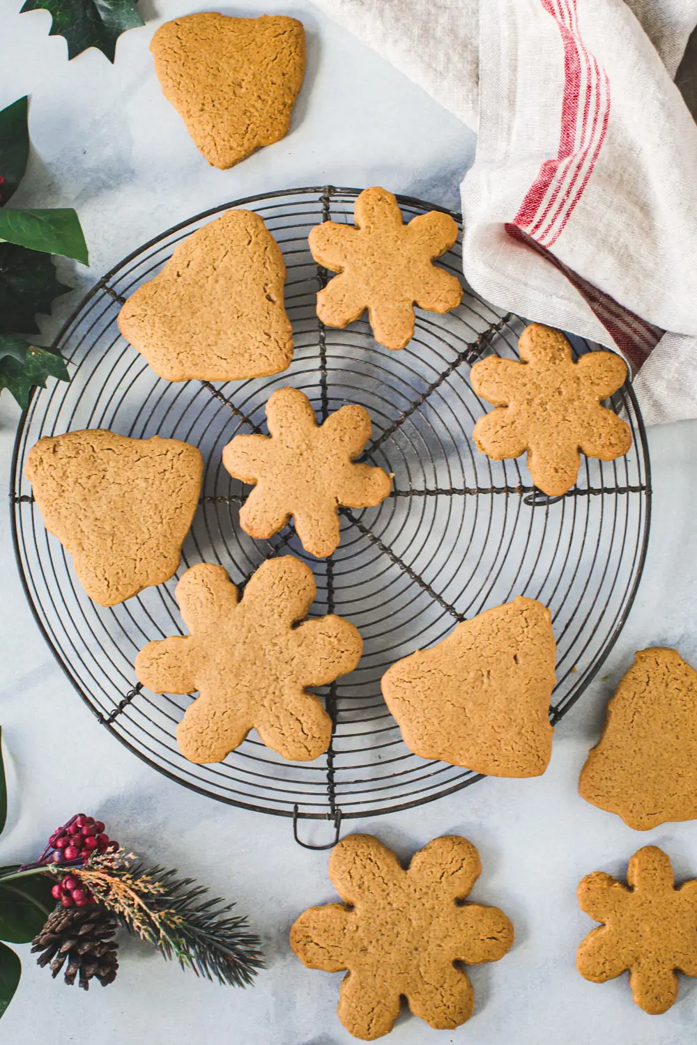 Plain gingerbread cookies on a round wire rack.