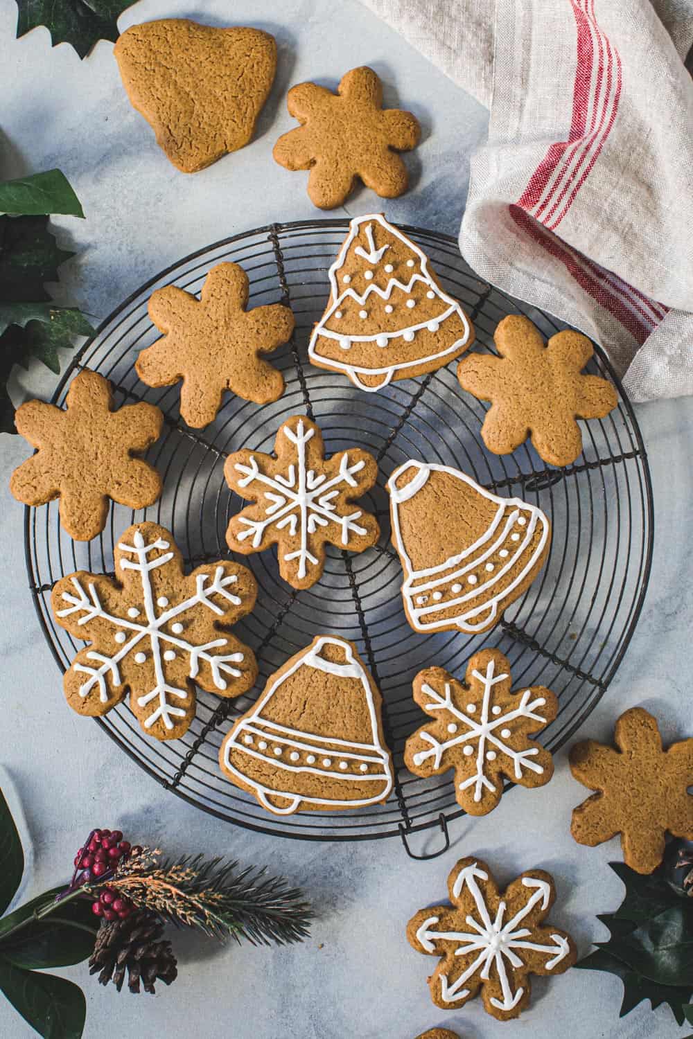 Iced gingerbread cutout cookies on a wire rack.
