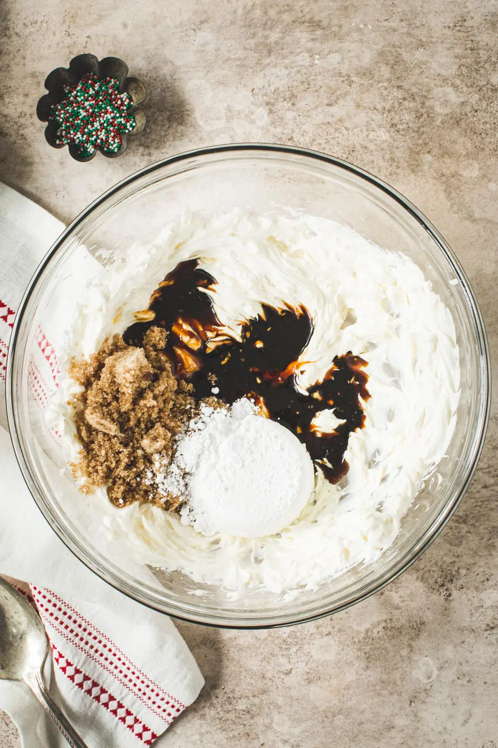 Gingerbread cheesecake dip ingredients in glass mixing bowl.