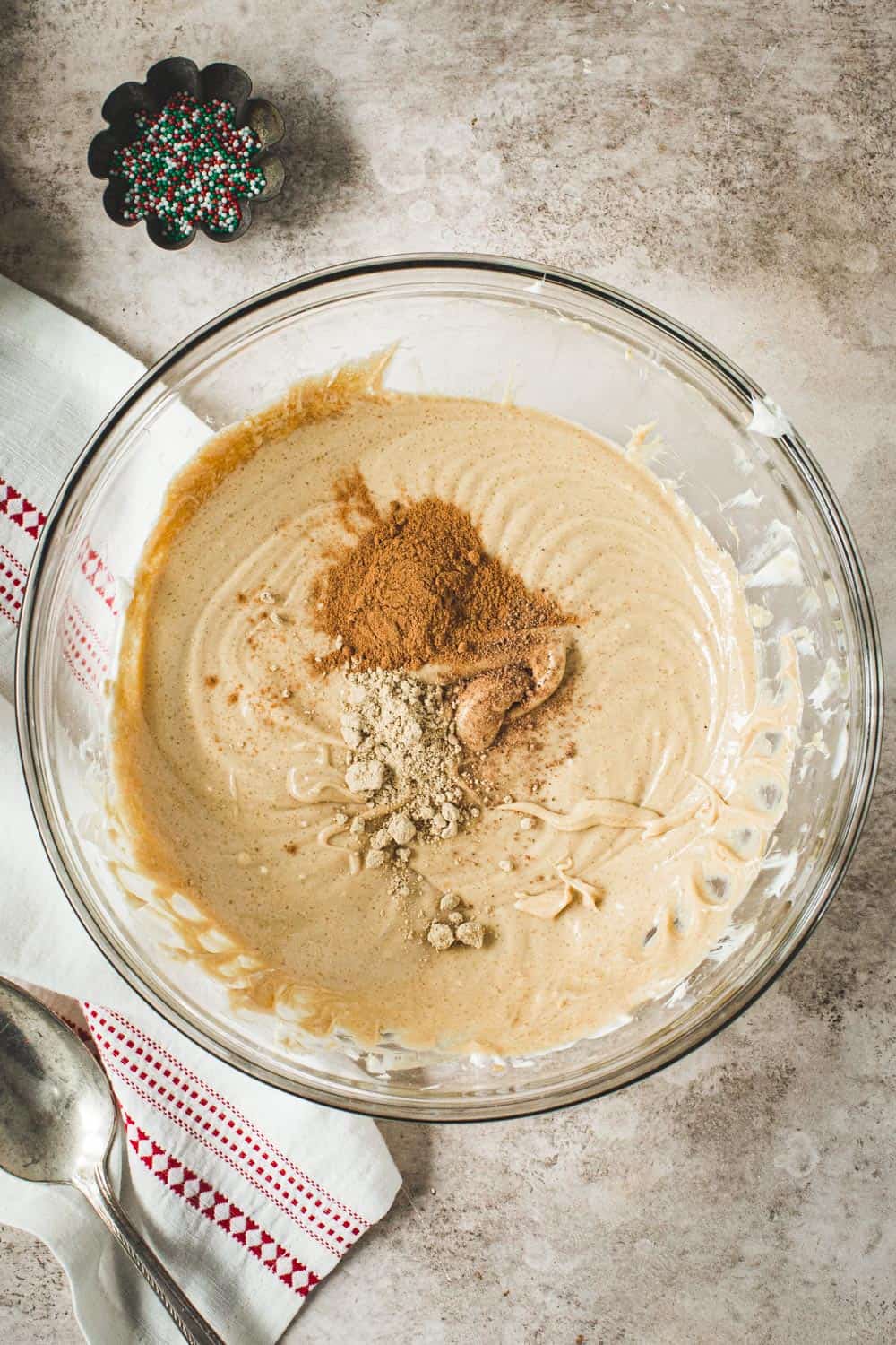Gingerbread cheesecake dip cheesecake ingredients in glass mixing bowl.