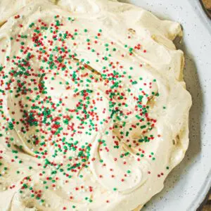 Gingerbread cheesecake dip in a white bowl with sprinkles.