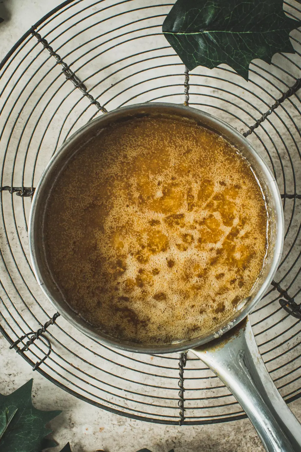 Boiling caramel for praline bars in a small pot.