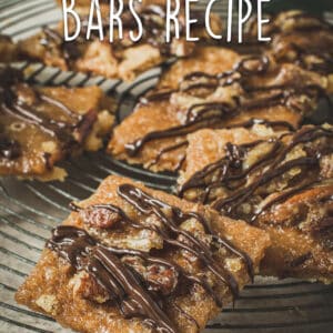 Praline bars on a round wire rack drizzled in chocolate.